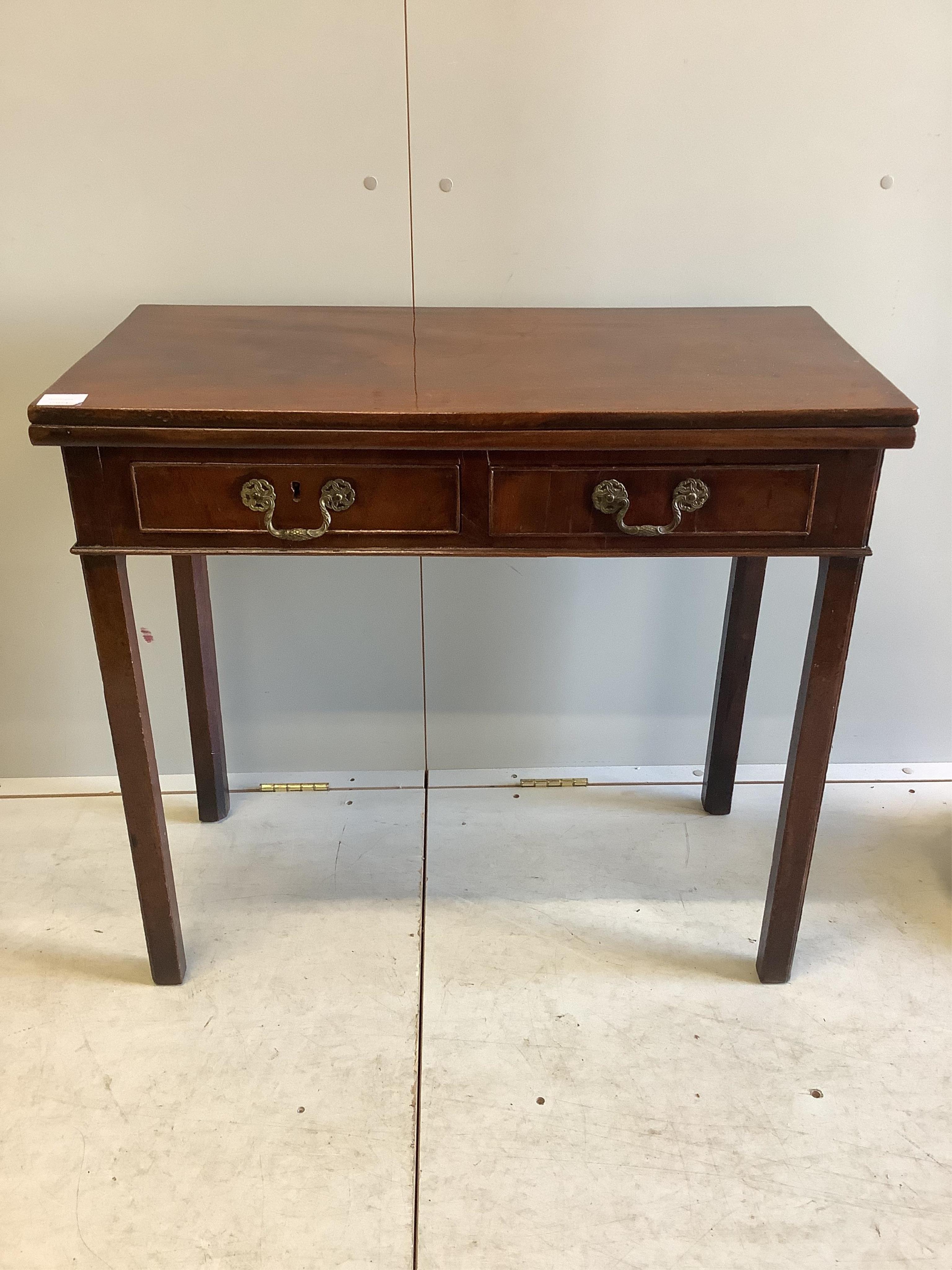 A George III rectangular mahogany folding card table, width 84cm, depth 41cm, height 76cm. Condition - fair